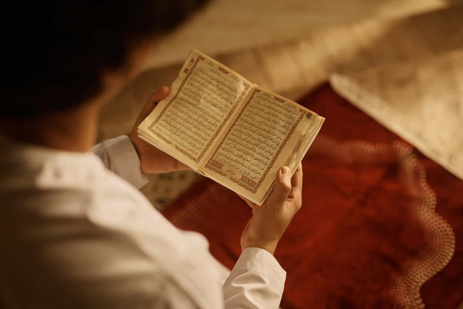 Close up of Muslim reading from Quran.