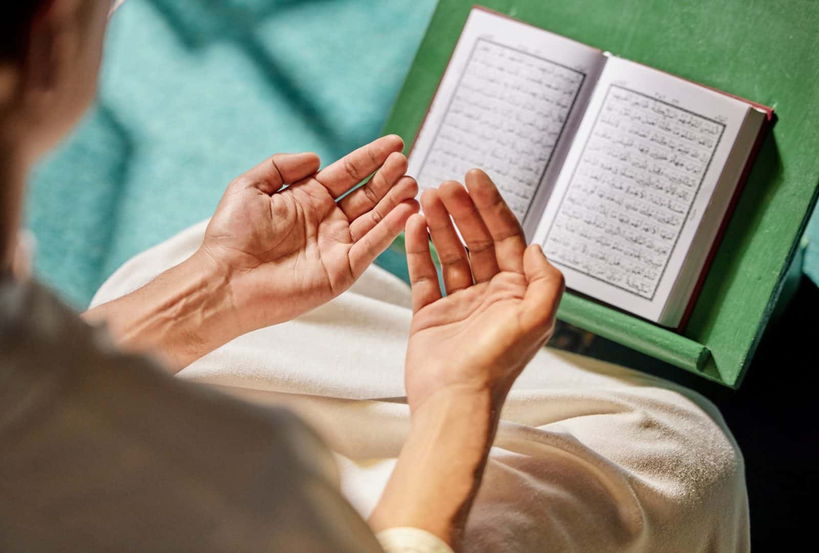 Quran, muslim and man hands praying to allah, god or holy spirit for islamic religion, faith and Sa